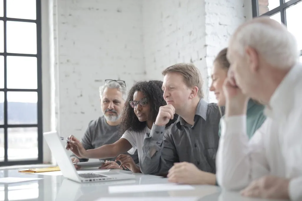 Sales team reviewing their pipeline together on a laptop