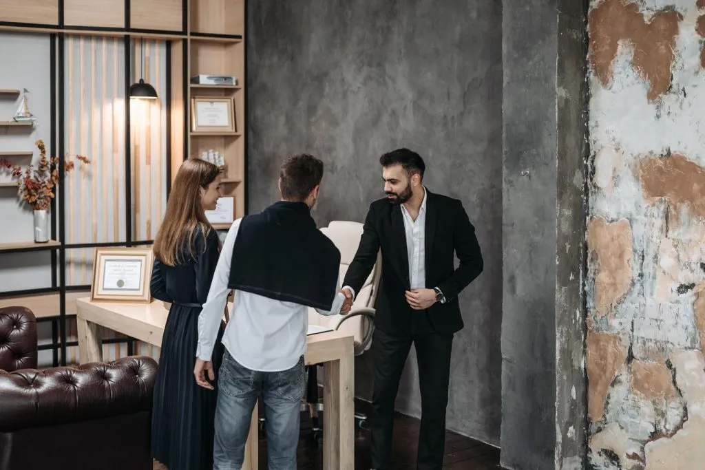 Advisor welcoming a client to a professional services office