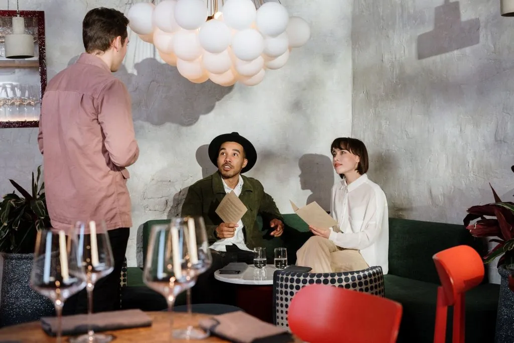 Restaurant guests choosing from the menu with a server